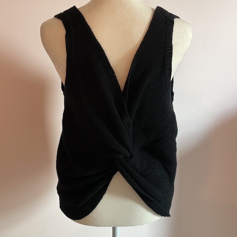 Super cute sleeveless black sweater with twist front (or back).
